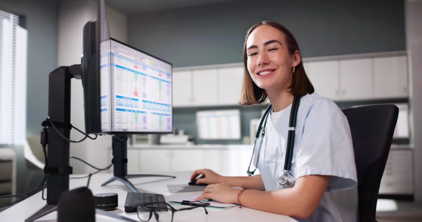 Healthcare professional reviewing digital records to support HCBS denial prevention and improved workflows.